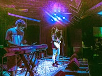 a man and a woman playing keyboards on stage