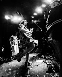 a black and white photo of a group of people on stage