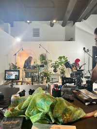 a man is sitting at a table in a recording studio